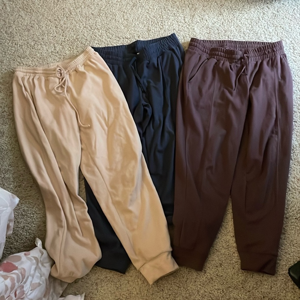 Three pairs of sweatpants or joggers size large